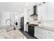 Modern kitchen with granite countertops, stainless steel appliances, and white cabinetry at 6408 Key Island Ave, Apollo Beach, FL 33572