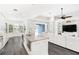 Open concept kitchen and living area with granite island and hardwood floors at 6408 Key Island Ave, Apollo Beach, FL 33572