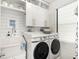 Bright laundry room with washer, dryer and extra storage at 6408 Key Island Ave, Apollo Beach, FL 33572