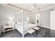 Bright bedroom with a four poster bed and ensuite bathroom access at 6408 Key Island Ave, Apollo Beach, FL 33572