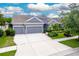 Two-story house with a three-car garage and a well-manicured lawn at 6429 Seasound Dr, Apollo Beach, FL 33572