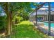 Landscaped backyard with lush greenery and pool view at 6429 Seasound Dr, Apollo Beach, FL 33572