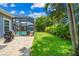 Landscaped backyard with a grassy lawn and grill at 6429 Seasound Dr, Apollo Beach, FL 33572