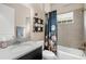 Bathroom with a shower/tub combo, floral shower curtain, and vanity at 6429 Seasound Dr, Apollo Beach, FL 33572