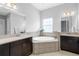 Bathroom with double sinks, soaking tub, and separate shower at 6429 Seasound Dr, Apollo Beach, FL 33572