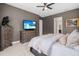 Spacious bedroom with large TV, dresser, and comfortable bedding at 6429 Seasound Dr, Apollo Beach, FL 33572