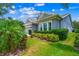 Gray house with lush landscaping and a three-car garage at 6429 Seasound Dr, Apollo Beach, FL 33572