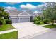 Gray house with three-car garage and manicured landscaping at 6429 Seasound Dr, Apollo Beach, FL 33572