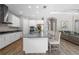 Modern kitchen featuring white cabinets, stainless steel appliances, and a large island at 6429 Seasound Dr, Apollo Beach, FL 33572