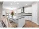 Modern kitchen with white cabinets, a large island, and stainless steel appliances at 6429 Seasound Dr, Apollo Beach, FL 33572