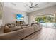 Relaxing living area with sectional sofa and large TV, overlooking the pool at 6429 Seasound Dr, Apollo Beach, FL 33572