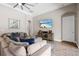 Comfortable living room with sectional sofa, large TV, and pool view at 6429 Seasound Dr, Apollo Beach, FL 33572