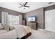 Comfortable main bedroom with a king-size bed and large TV at 6429 Seasound Dr, Apollo Beach, FL 33572