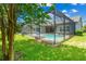 Screened pool and patio area with lush landscaping at 6429 Seasound Dr, Apollo Beach, FL 33572