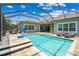 Luxury screened pool with patio and lounge chairs at 6429 Seasound Dr, Apollo Beach, FL 33572