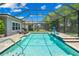 Screened pool with patio and a basketball hoop at 6429 Seasound Dr, Apollo Beach, FL 33572