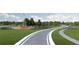 Community entrance with landscaping and signage at 6690 Michael Favor Way, Wesley Chapel, FL 33545