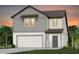 Two-story house with gray and white siding, two-car garage, and landscaping at 6690 Michael Favor Way, Wesley Chapel, FL 33545