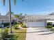 Single-story home with attached garage and landscaped front yard at 7710 Palm Aire Ln, Sarasota, FL 34243