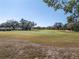 Golf course view with mature trees at 7710 Palm Aire Ln, Sarasota, FL 34243