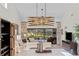 Bright living room with lake view, comfy seating, and modern chandelier at 7710 Palm Aire Ln, Sarasota, FL 34243