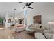 Open living area with adjoining kitchen, featuring comfortable sofas and a stylish coffee table at 7710 Palm Aire Ln, Sarasota, FL 34243