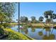 Peaceful waterfront view with palm trees and golf course at 7710 Palm Aire Ln, Sarasota, FL 34243