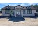 Newly built home exterior with light colored walls and dark accents at 8312 Cosme Rd, Odessa, FL 33556