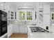 White kitchen with stainless steel appliances and marble countertops at 836 S Bayside Dr, Tampa, FL 33609