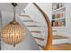 Curved staircase with unique light fixture and built-in bookshelves at 836 S Bayside Dr, Tampa, FL 33609