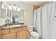 Clean bathroom with granite vanity, light wood cabinets and shower at 10265 Gandy N Blvd # 1715, St Petersburg, FL 33702