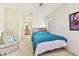 Bedroom with teal bedding, ensuite bathroom access, and comfy chair at 10265 Gandy N Blvd # 1715, St Petersburg, FL 33702