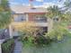 Two-story condo building with balcony and landscaping at 10265 Gandy N Blvd # 1715, St Petersburg, FL 33702