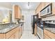Well-equipped kitchen featuring granite counters and ample cabinetry at 10265 Gandy N Blvd # 1715, St Petersburg, FL 33702