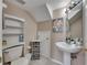 Small bathroom with pedestal sink and built-in shelving at 10817 Keys Gate Dr, Riverview, FL 33579