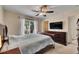 Primary bedroom with large bed, dresser, and ceiling fan at 10817 Keys Gate Dr, Riverview, FL 33579