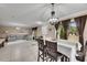 Open concept dining room with a chandelier, table and chairs, and view to backyard at 10817 Keys Gate Dr, Riverview, FL 33579