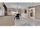 Dining area with kitchen access, a chandelier, and a view into the living room at 10817 Keys Gate Dr, Riverview, FL 33579
