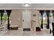 Bright and airy entryway with tile flooring, a half wall, and a bench at 10817 Keys Gate Dr, Riverview, FL 33579