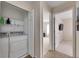 Bright laundry room with washer, dryer, and shelving at 10817 Keys Gate Dr, Riverview, FL 33579
