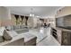 Open living room with sectional sofa, dining area, and kitchen view at 10817 Keys Gate Dr, Riverview, FL 33579