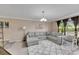 Bright living room with sectional sofa and large windows at 10817 Keys Gate Dr, Riverview, FL 33579