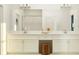 Double vanity bathroom with a large mirror and white cabinets at 10860 Ibis Brook Ct, Land O Lakes, FL 34638