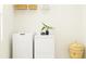 Bright laundry room with washer, dryer, and overhead shelving at 10860 Ibis Brook Ct, Land O Lakes, FL 34638