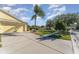 Exterior view of a yellow house with a spacious yard at 11505 Captiva Kay Dr, Riverview, FL 33569