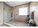 Bathroom with a walk-in shower and pebble stone shower floor at 11911 Mandevilla Ct, Tampa, FL 33626