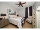 Cozy bedroom with an iron bed frame and neutral color scheme at 11911 Mandevilla Ct, Tampa, FL 33626