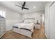 Spacious bedroom with light wood floors and white furniture at 11911 Mandevilla Ct, Tampa, FL 33626