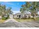 House exterior with gray siding, stone accents, and lush landscaping at 11911 Mandevilla Ct, Tampa, FL 33626