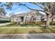 One-story home with gray siding, black shutters, and landscaped yard at 11911 Mandevilla Ct, Tampa, FL 33626